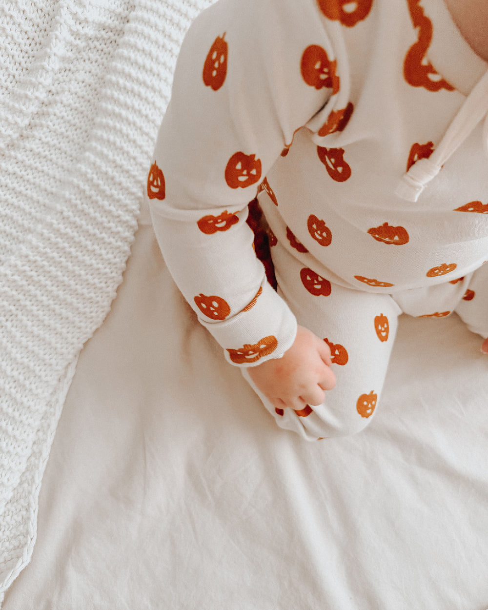 Child wearing Kids' Organic L/Sleeve PJ Set in Jack-o-Lanterns.