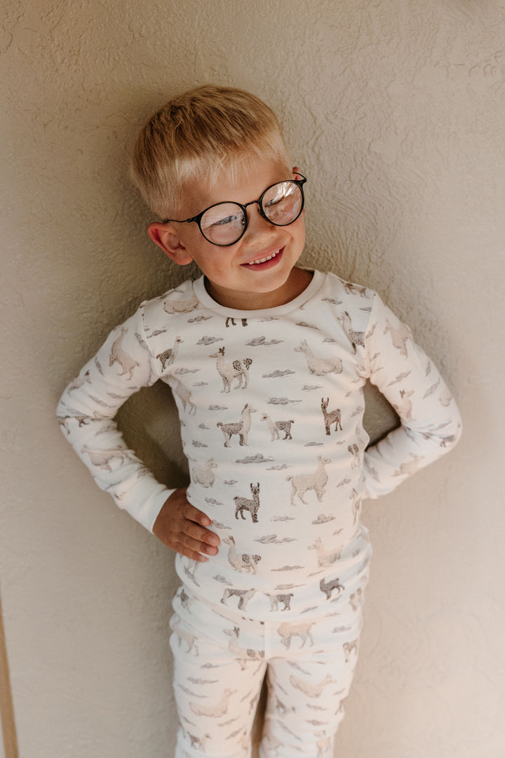 Child wearing Kids' Organic L/Sleeve PJ Set in Llama.