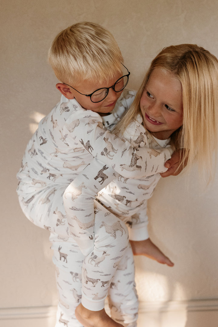 Child wearing Kids' Organic L/Sleeve PJ Set in Llama.