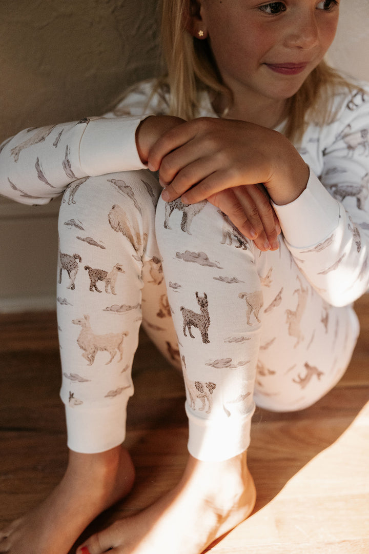 Child wearing Kids' Organic L/Sleeve PJ Set in Llama.