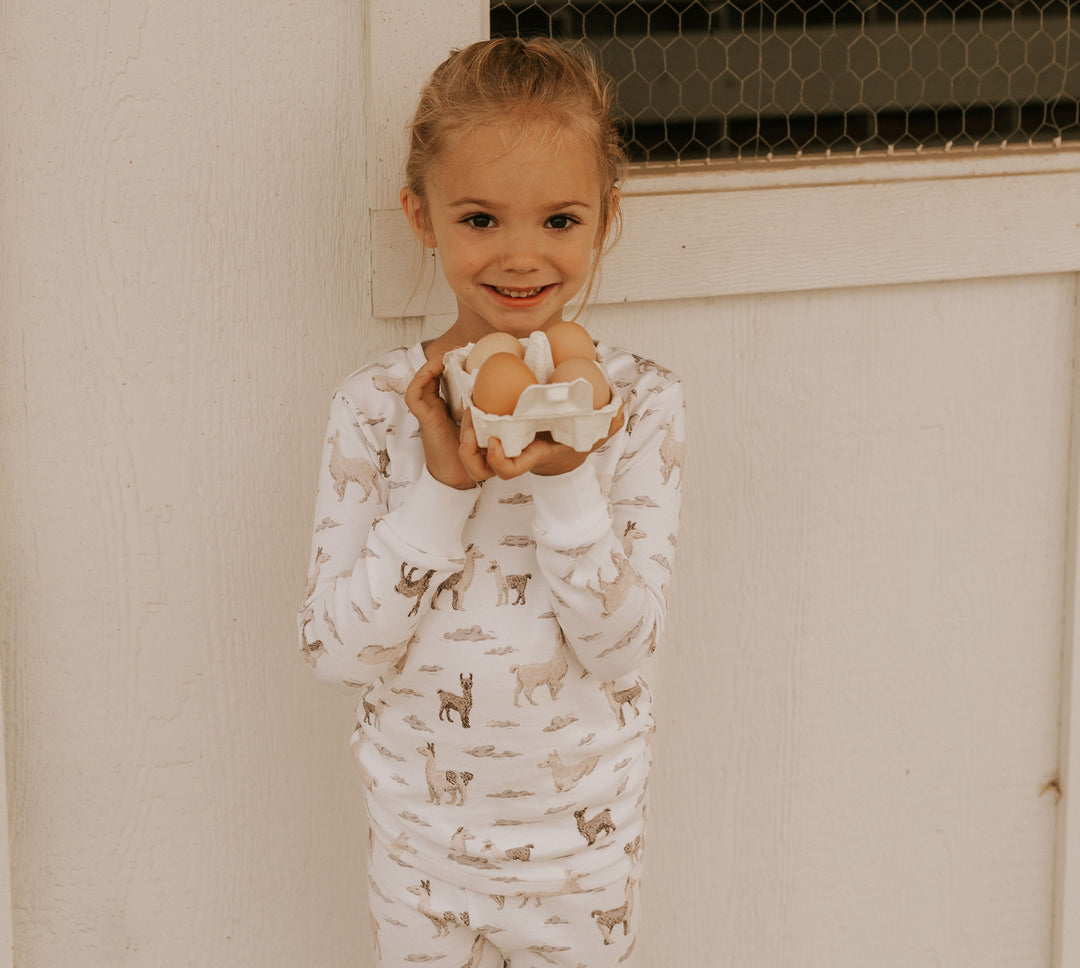 Child wearing Kids' Organic L/Sleeve PJ Set in Llama.