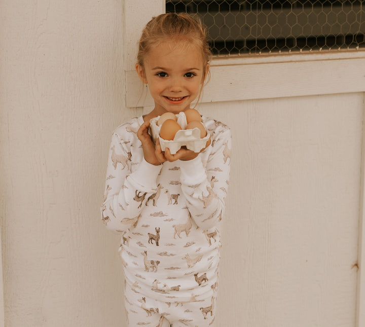 Child wearing Kids' Organic L/Sleeve PJ Set in Llama.