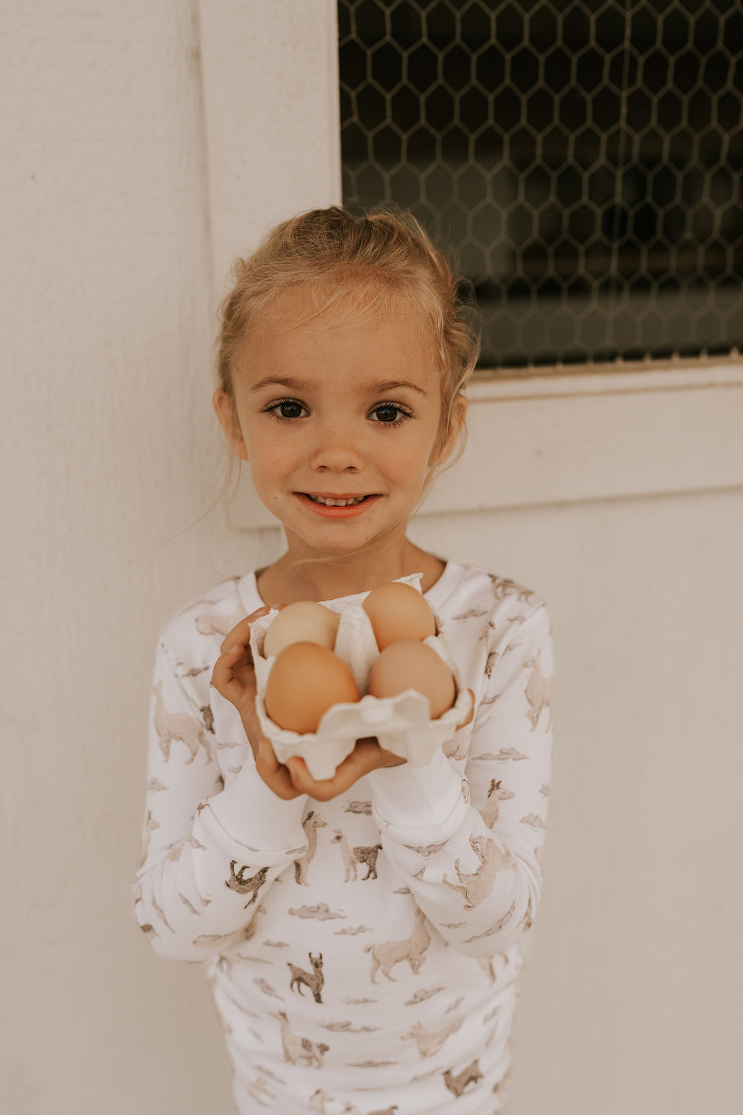 Child wearing Kids' Organic L/Sleeve PJ Set in Llama.
