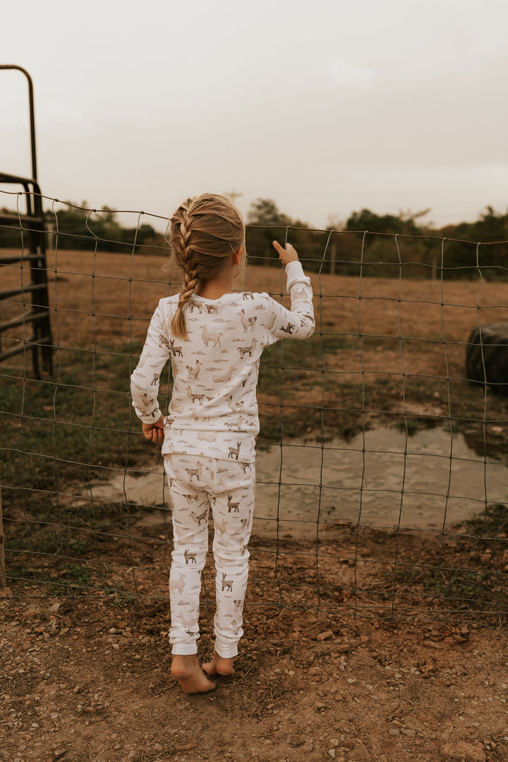 Child wearing Kids' Organic L/Sleeve PJ Set in Llama.