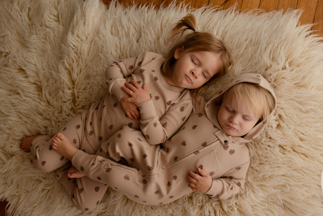 Child wearing Kids' Organic L/Sleeve PJ Set in Oatmeal Pinecone.