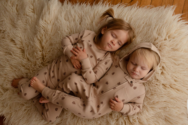 Child wearing Kids' Organic L/Sleeve PJ Set in Oatmeal Pinecone.
