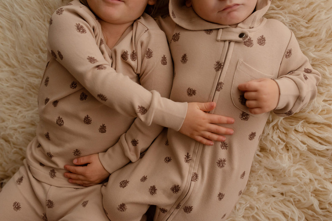 Child wearing Kids' Organic L/Sleeve PJ Set in Oatmeal Pinecone.