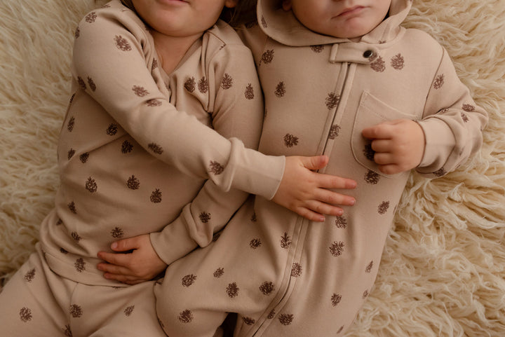 Child wearing Kids' Organic L/Sleeve PJ Set in Oatmeal Pinecone.