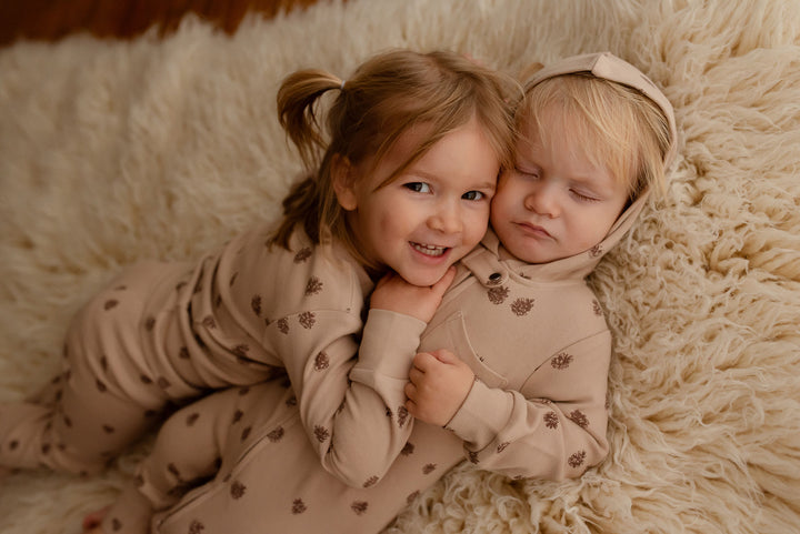 Child wearing Kids' Organic L/Sleeve PJ Set in Oatmeal Pinecone.