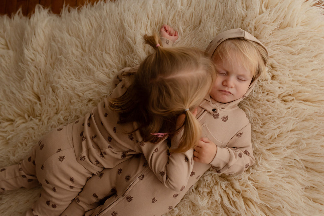 Child wearing Kids' Organic L/Sleeve PJ Set in Oatmeal Pinecone.