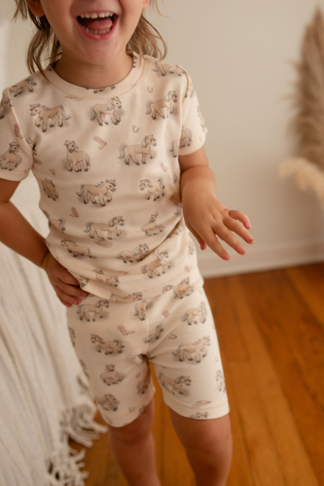Child wearing Kids' Organic Short-Sleeve PJ Set in Blush Boots.