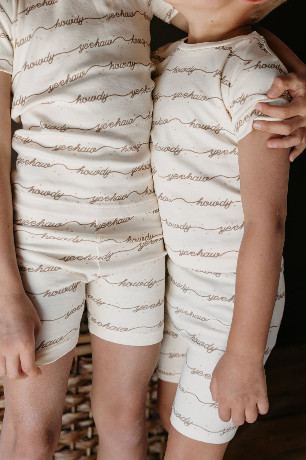 Child wearing Kids' Organic Short-Sleeve PJ Set in Howdy.