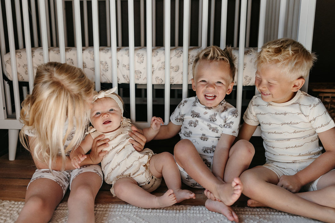 Child wearing Kids' Organic Short-Sleeve PJ Set in Howdy.