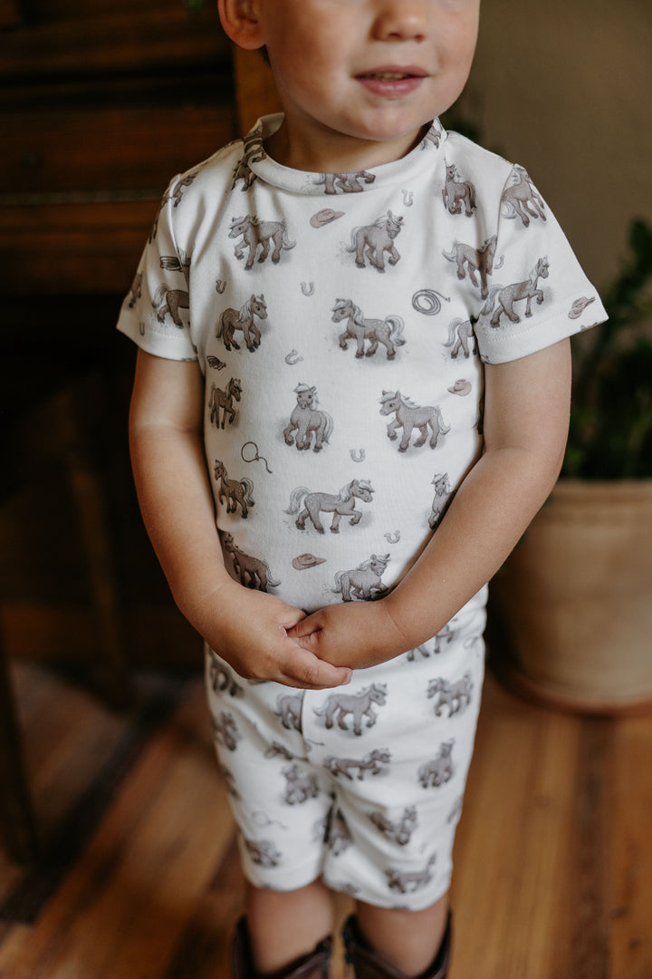Child wearing Kids' Organic Short-Sleeve PJ Set in Little Lasso.