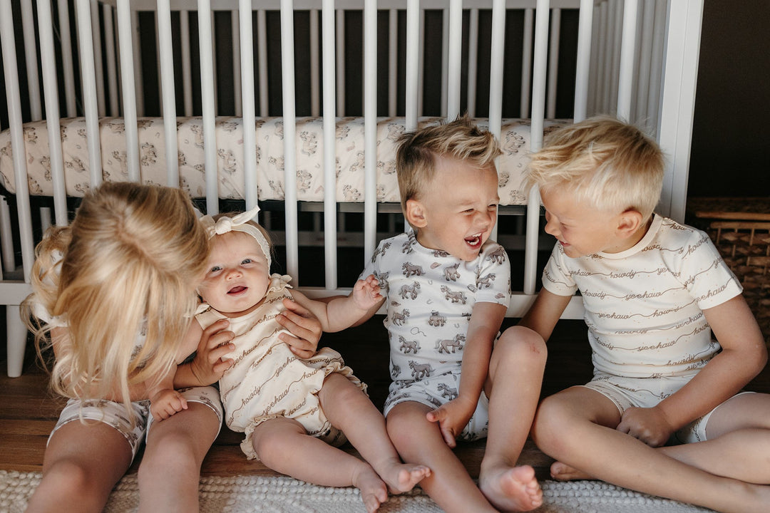 Child wearing Kids' Organic Short-Sleeve PJ Set in Little Lasso.