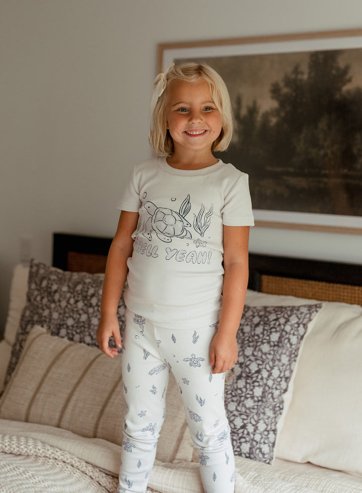 Child wearing Kids' Organic S/Sleeve PJ Set in Sea Turtle.