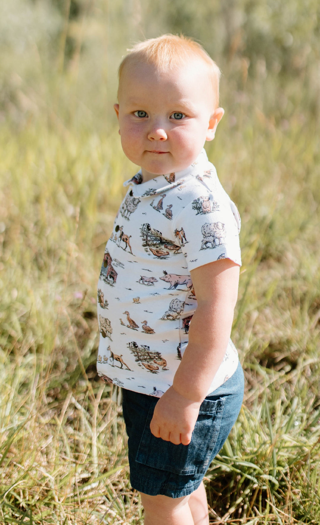 Child wearing Kids' Organic Button-Up S/Sleeve in Farm Friends.