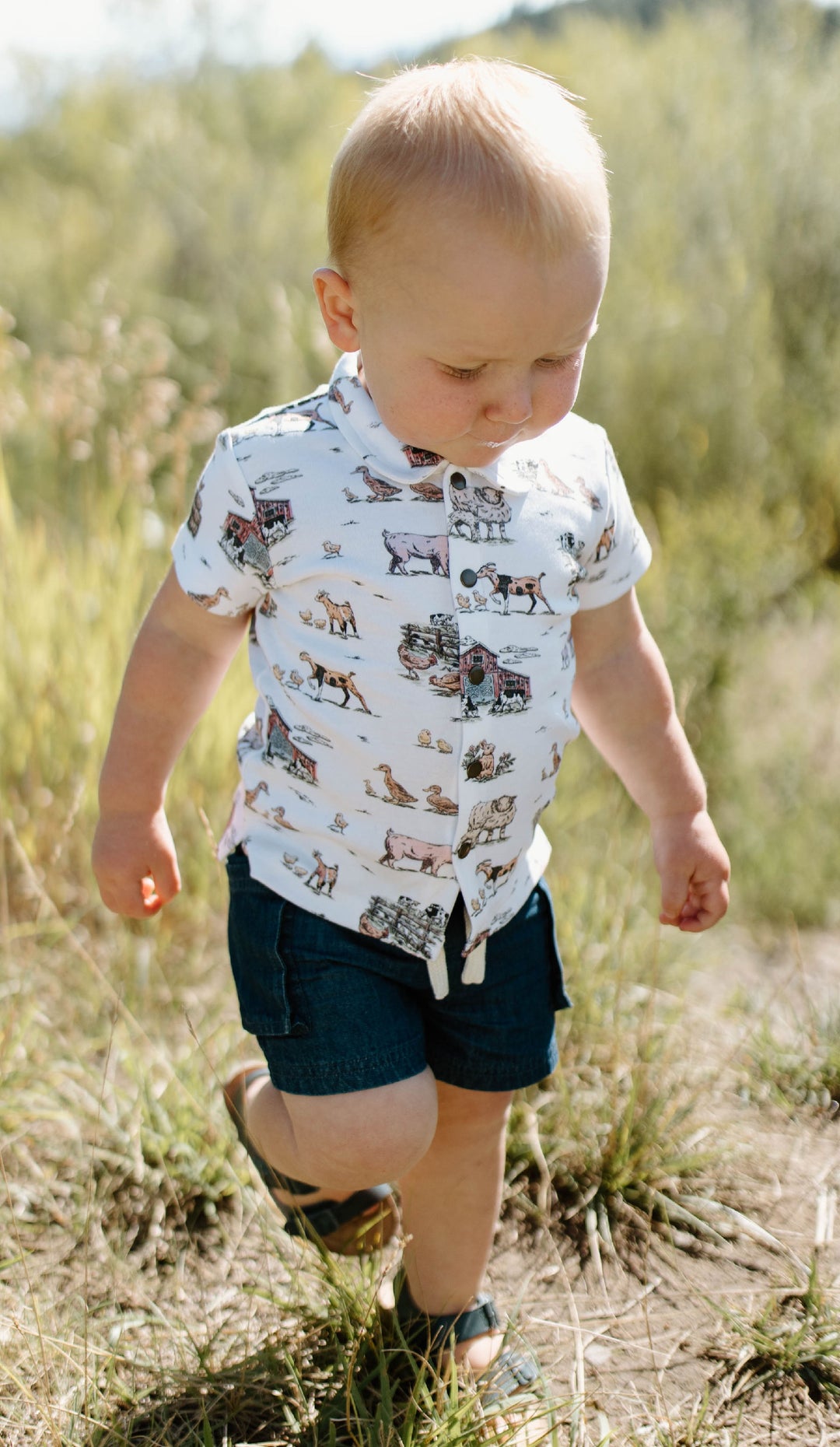Child wearing Kids' Organic Button-Up S/Sleeve in Farm Friends.