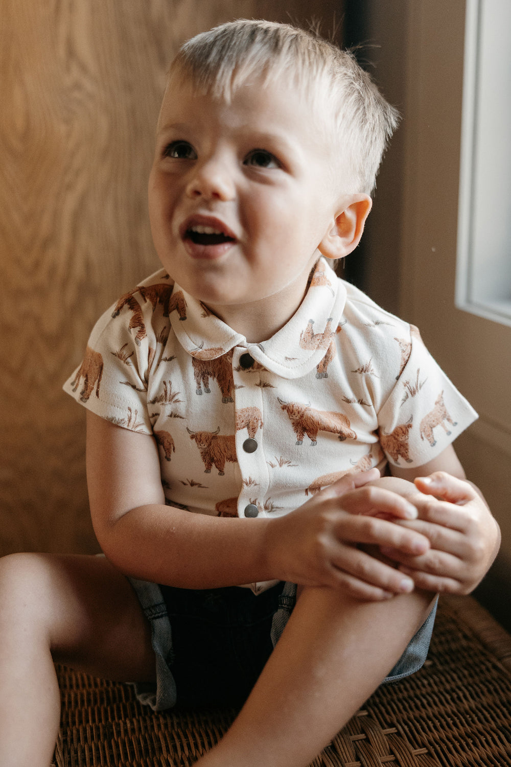 Child wearing Kids' Organic Button-Up S/Sleeve in Highland Cow.