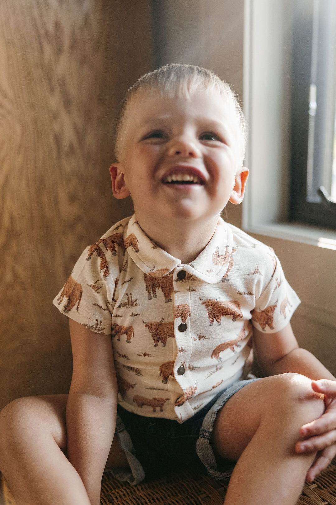 Child wearing Kids' Organic Button-Up S/Sleeve in Highland Cow.