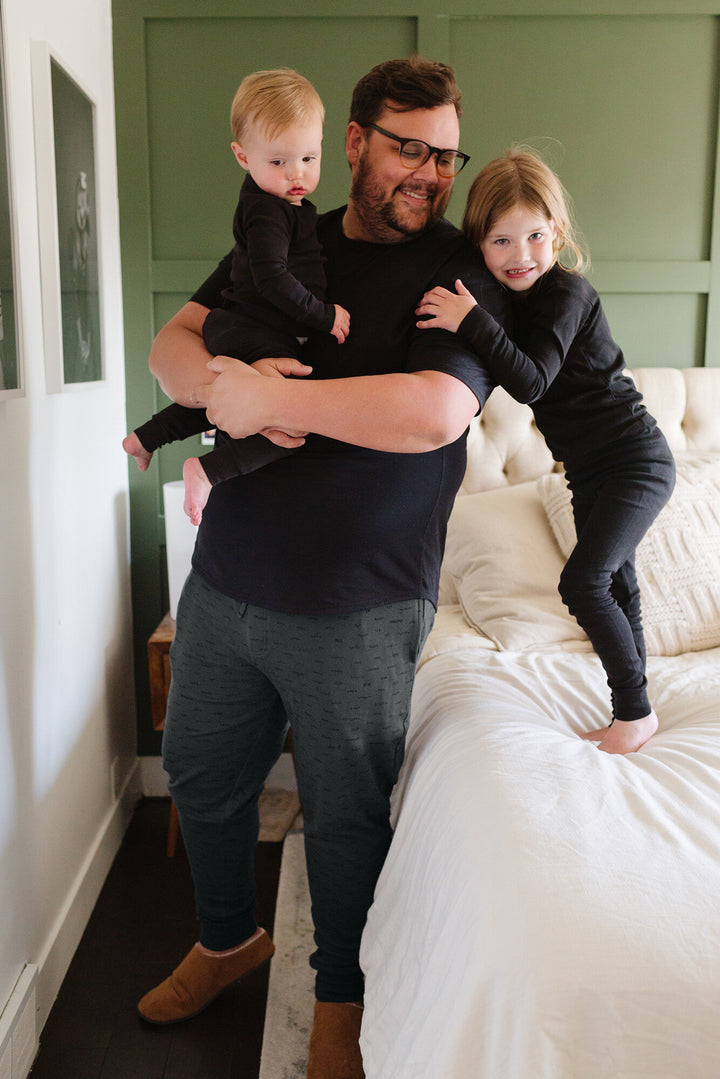 Man with children wearing Men's Organic Dad Joggers in Charcoal.