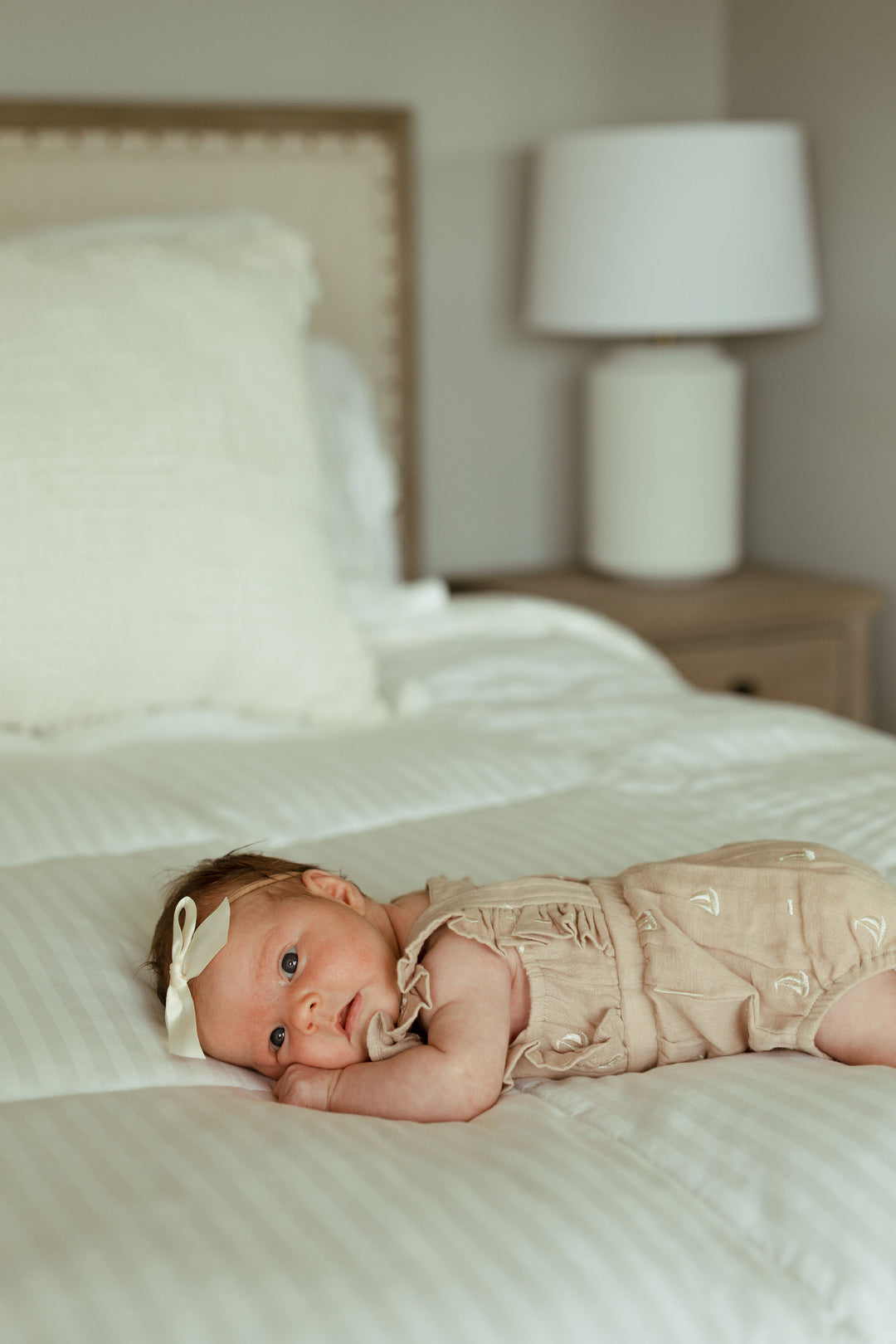 Child wearing Organic Muslin Ruffle Bodysuit in Oatmeal Sailboat.