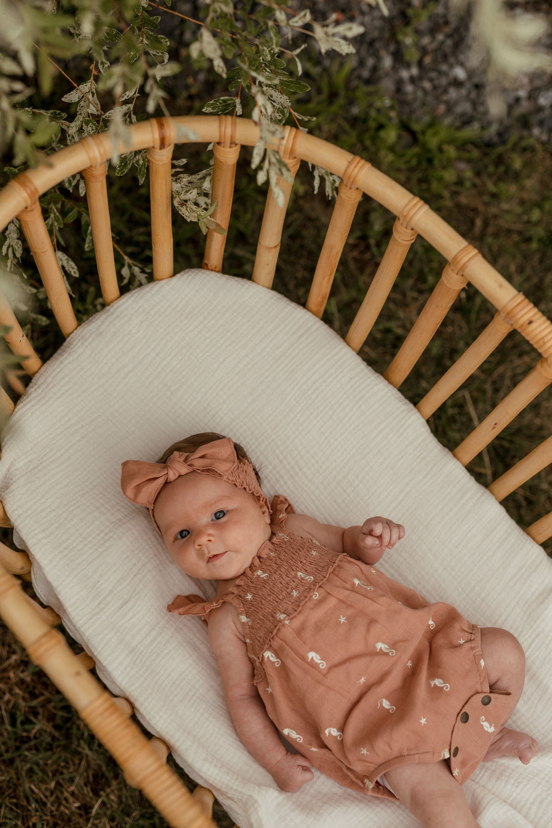 Child wearing Organic Muslin Sleeveless Bodysuit in Adobe Seahorse.