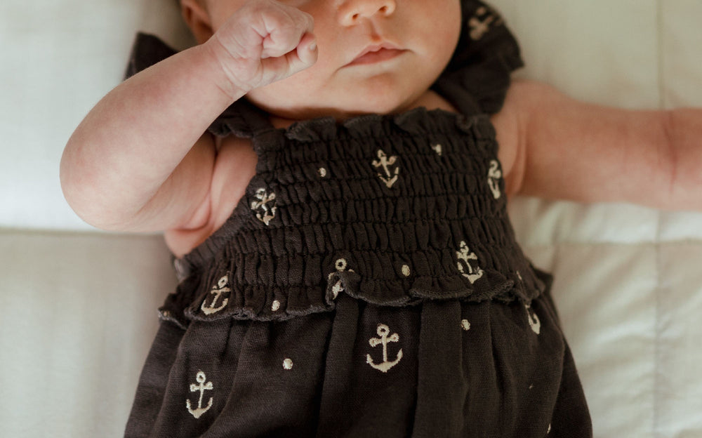 Child wearing Organic Muslin Sleeveless Bodysuit in Chia Anchor.