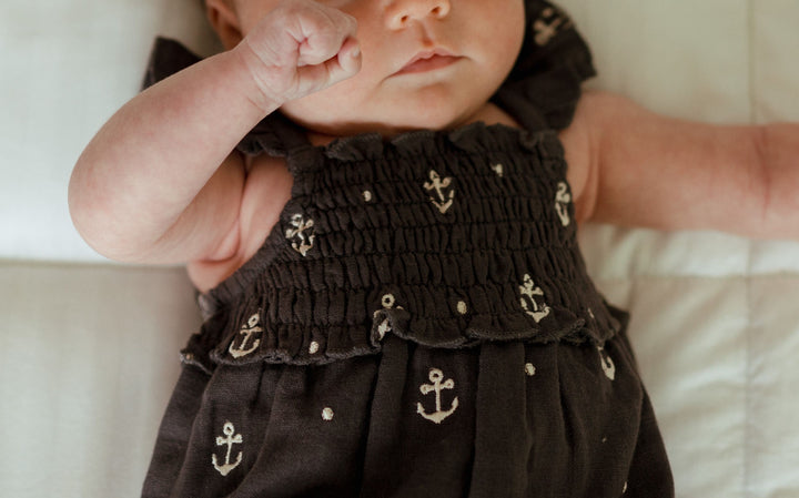 Child wearing Organic Muslin Sleeveless Bodysuit in Chia Anchor.