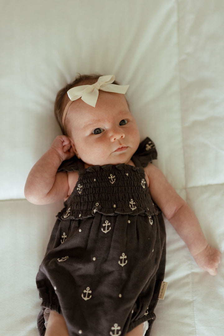 Child wearing Organic Muslin Sleeveless Bodysuit in Chia Anchor.