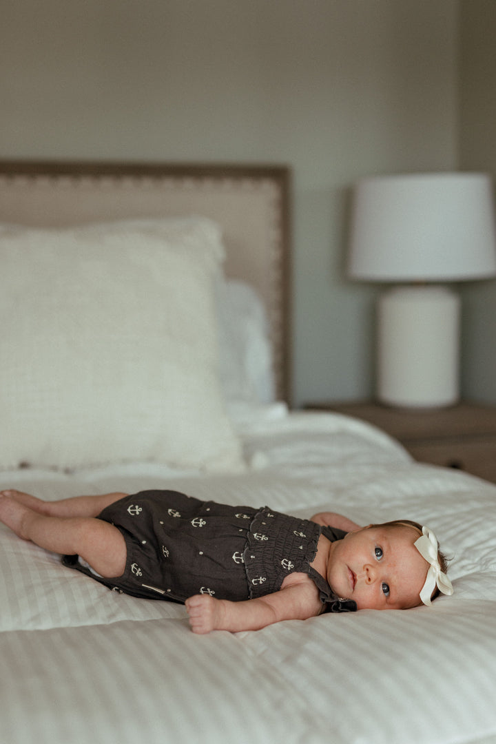 Child wearing Organic Muslin Sleeveless Bodysuit in Chia Anchor.