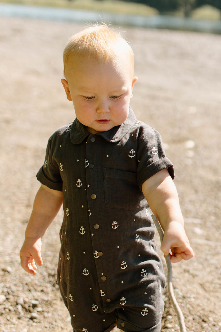 Child wearing Organic Muslin S/Sleeve Coverall in Chia Anchor.