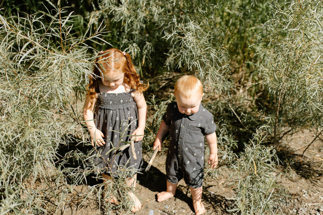 Child wearing Organic Muslin S/Sleeve Coverall in Chia Anchor.