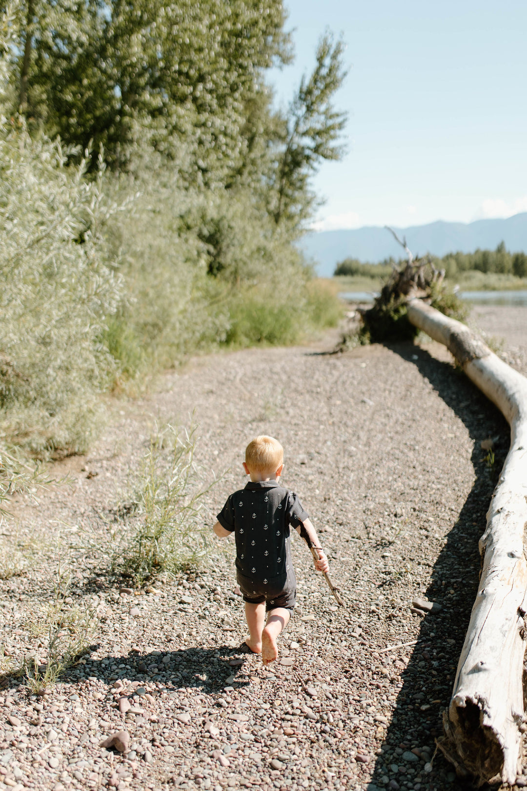 Child wearing Organic Muslin S/Sleeve Coverall in Chia Anchor.