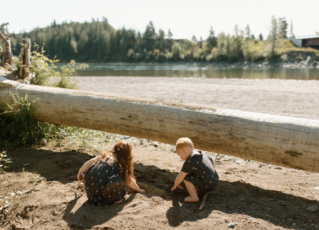 Child wearing Organic Muslin S/Sleeve Coverall in Chia Anchor.