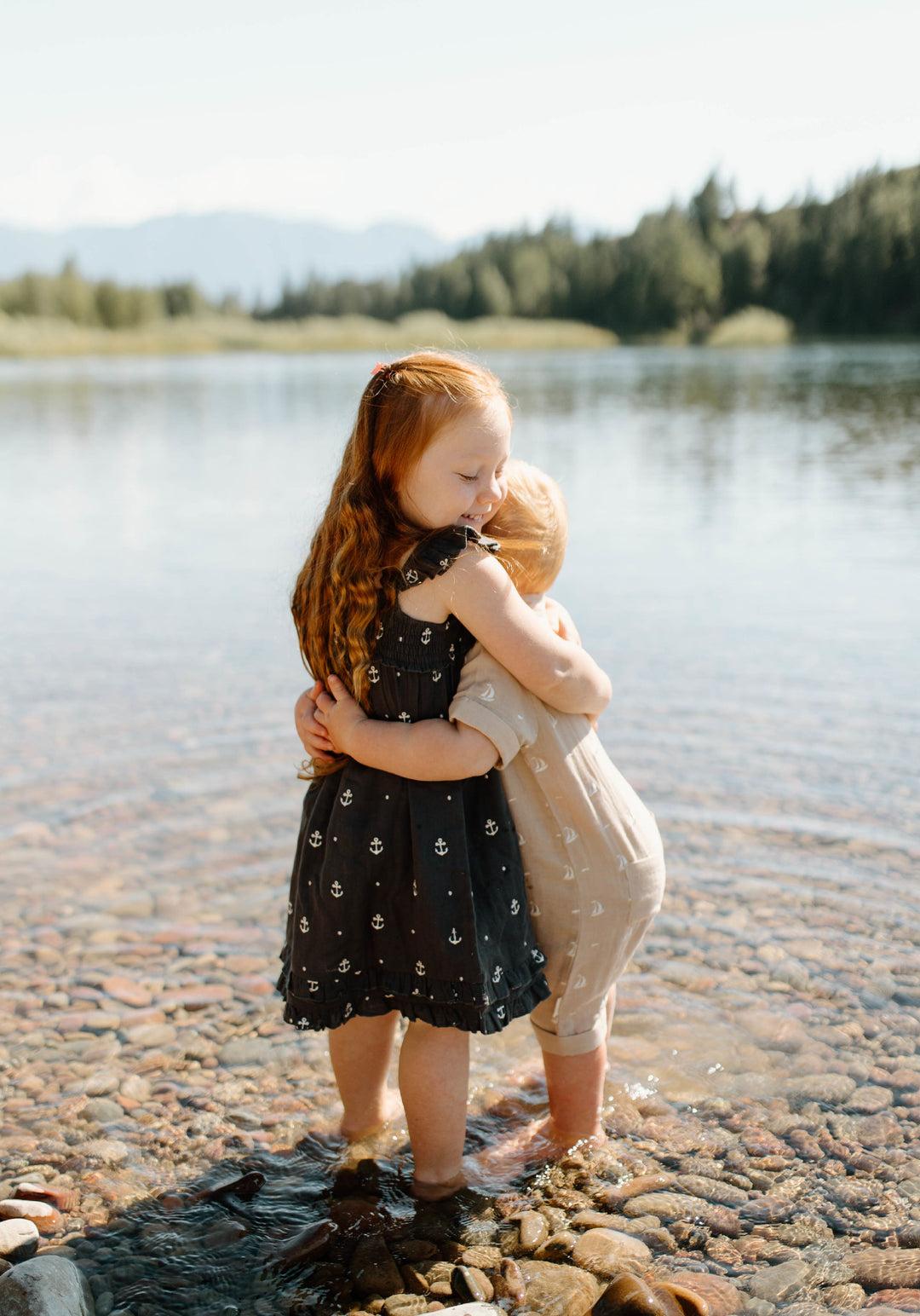 Child wearing Organic Muslin S/Sleeve Coverall in Oatmeal Sailboat.