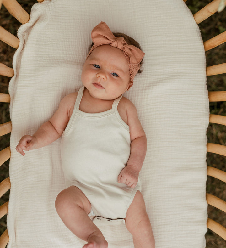 Child wearing Organic Muslin Smocked Headband in Adobe.