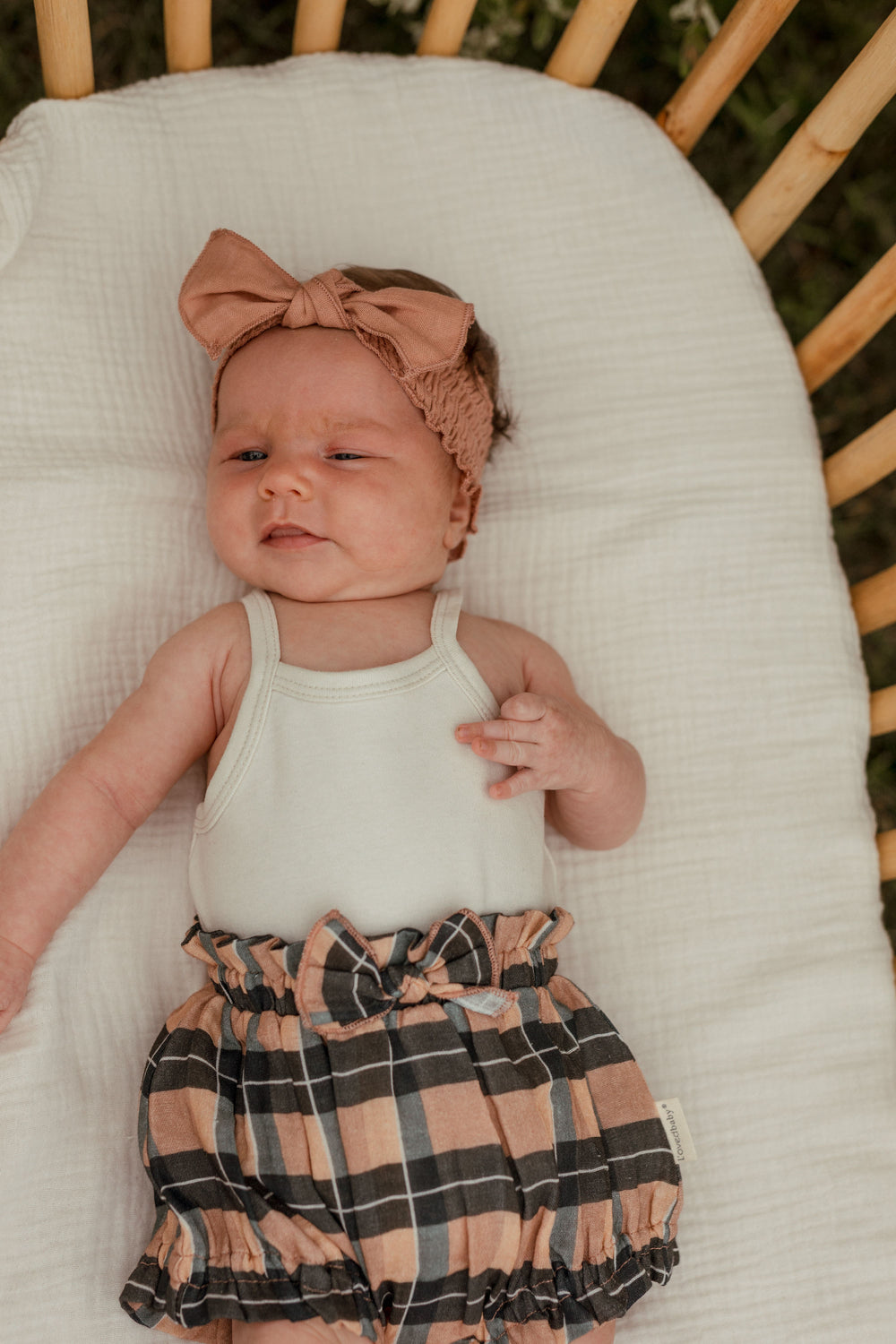 Child wearing Organic Muslin Ruffle Bloomer in Adobe Chia Plaid.