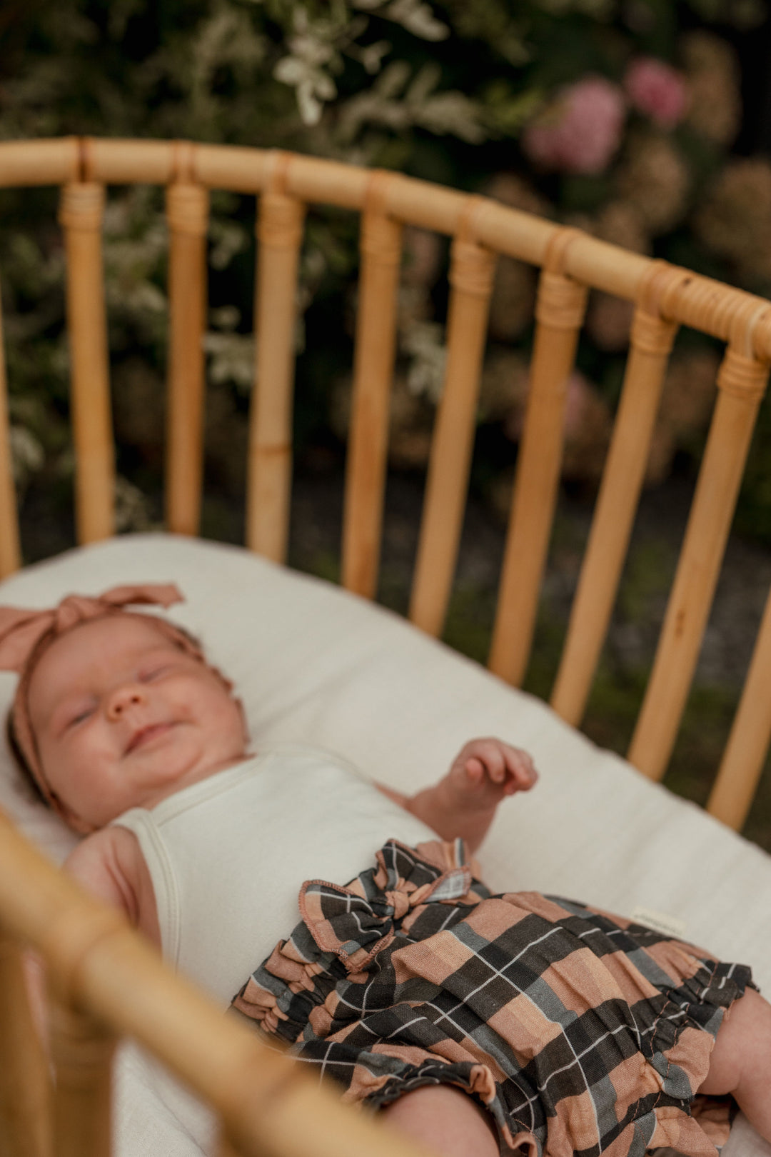Child wearing Organic Muslin Ruffle Bloomer in Adobe Chia Plaid.