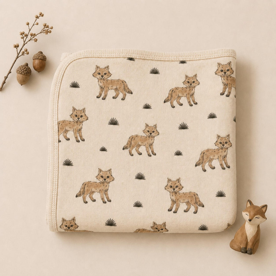 Child wearing Organic Blanket in Coyote.