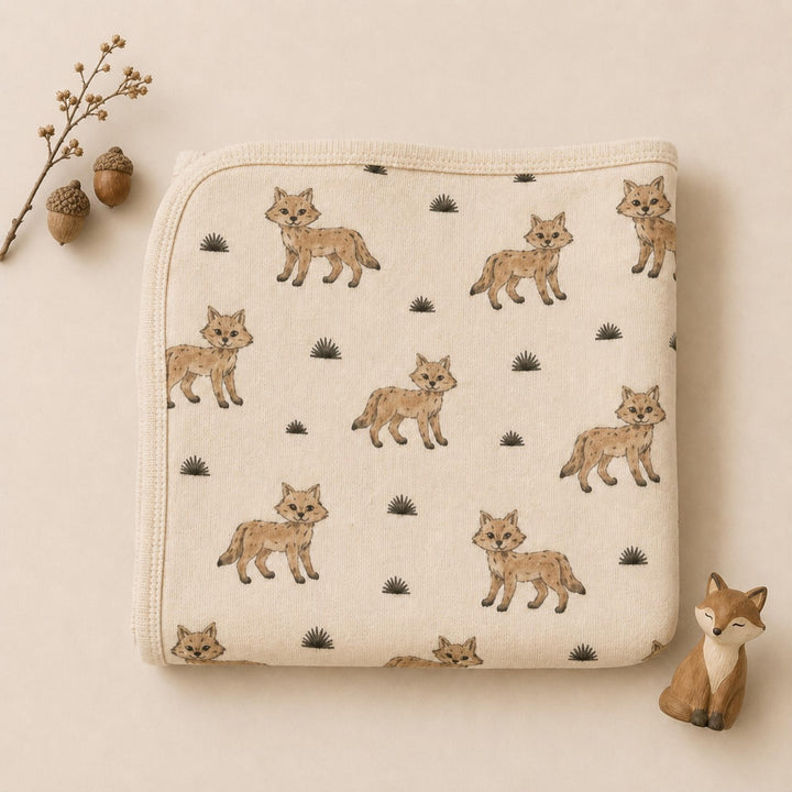 Child wearing Organic Blanket in Coyote.