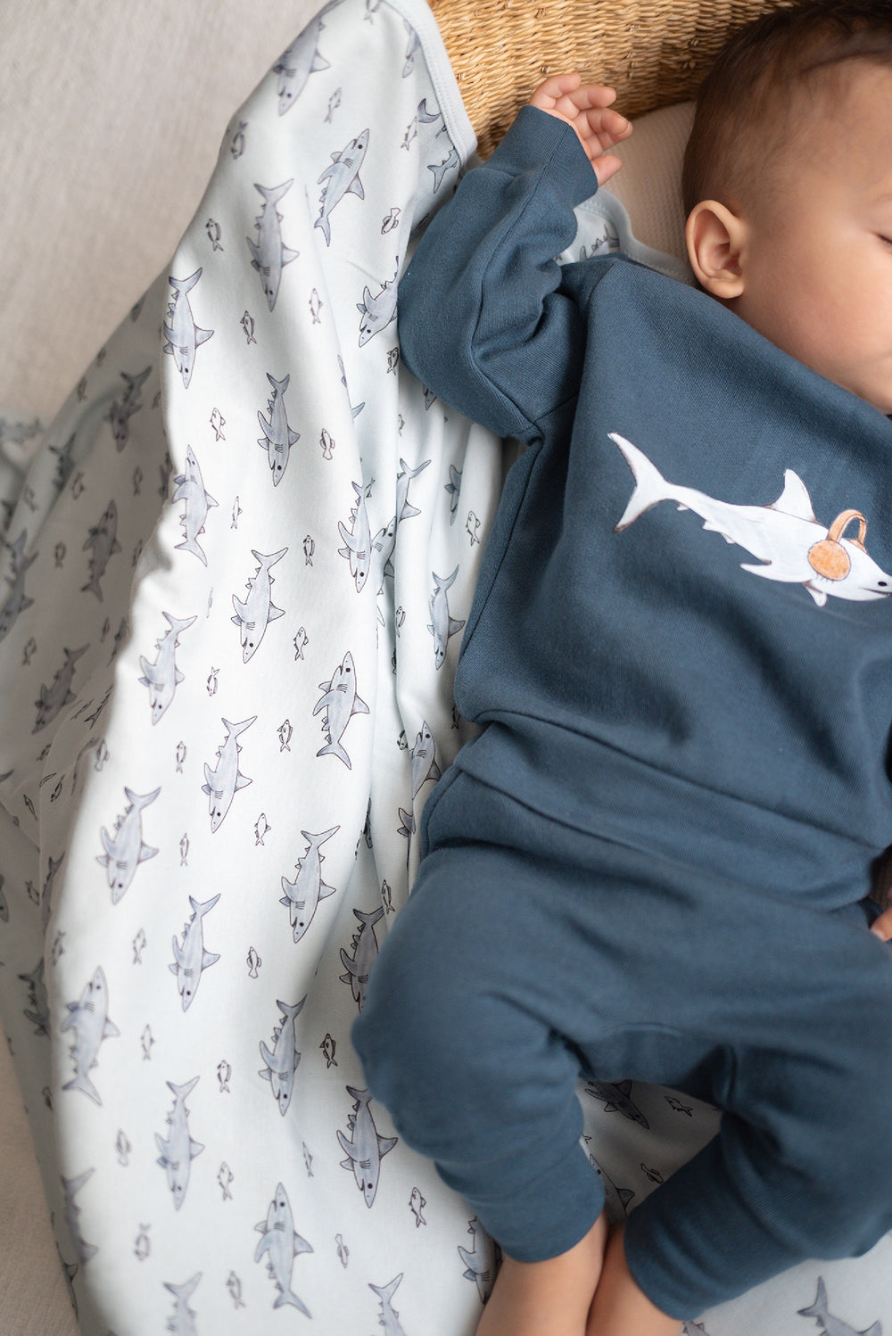 Child wearing Organic Blanket in Sharks.
