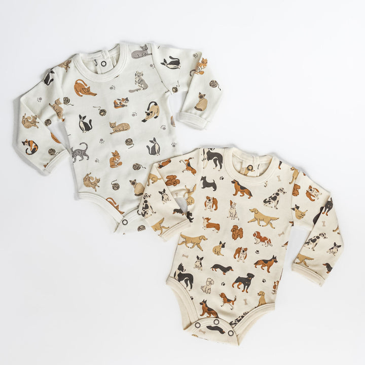 Child wearing Organic Long-Sleeve Bodysuit in 9 Lives.