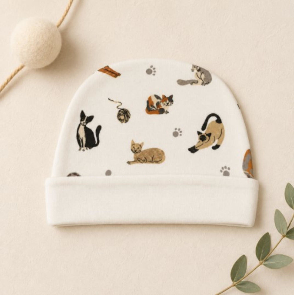 Child wearing Reversible Organic Beanie in 9 Lives.