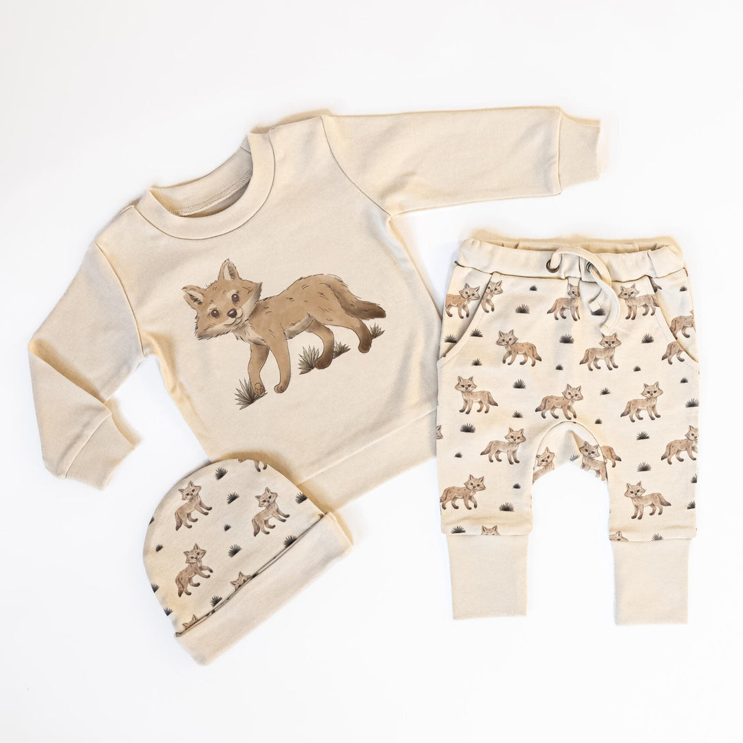 Child wearing Reversible Organic Beanie in Coyote.