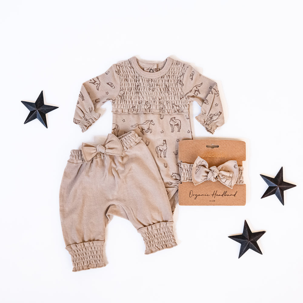 Child wearing Organic Smocked Chest Bodysuit in Mini Buckaroo.