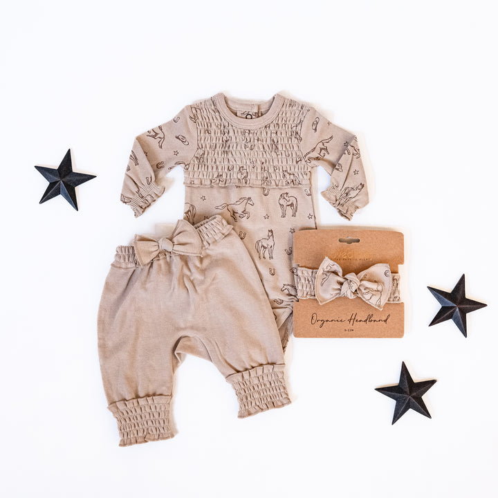 Child wearing Organic Smocked Chest Bodysuit in Mini Buckaroo.