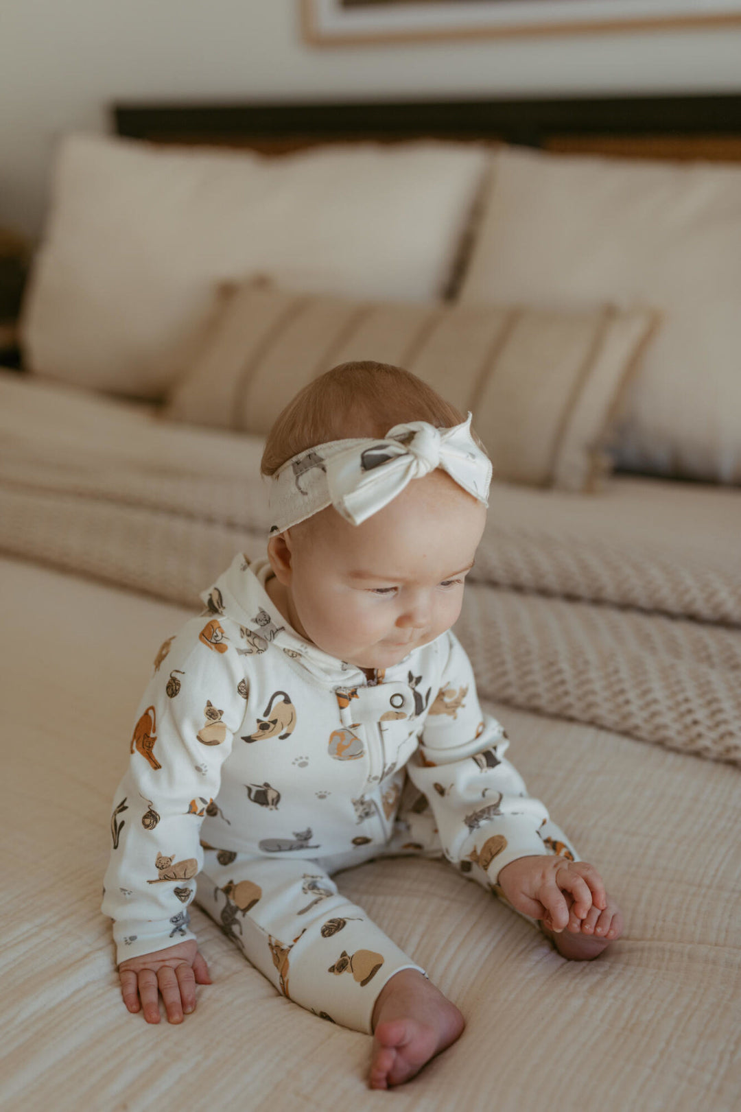 Child wearing Organic Hooded Zipper Romper in 9 Lives.