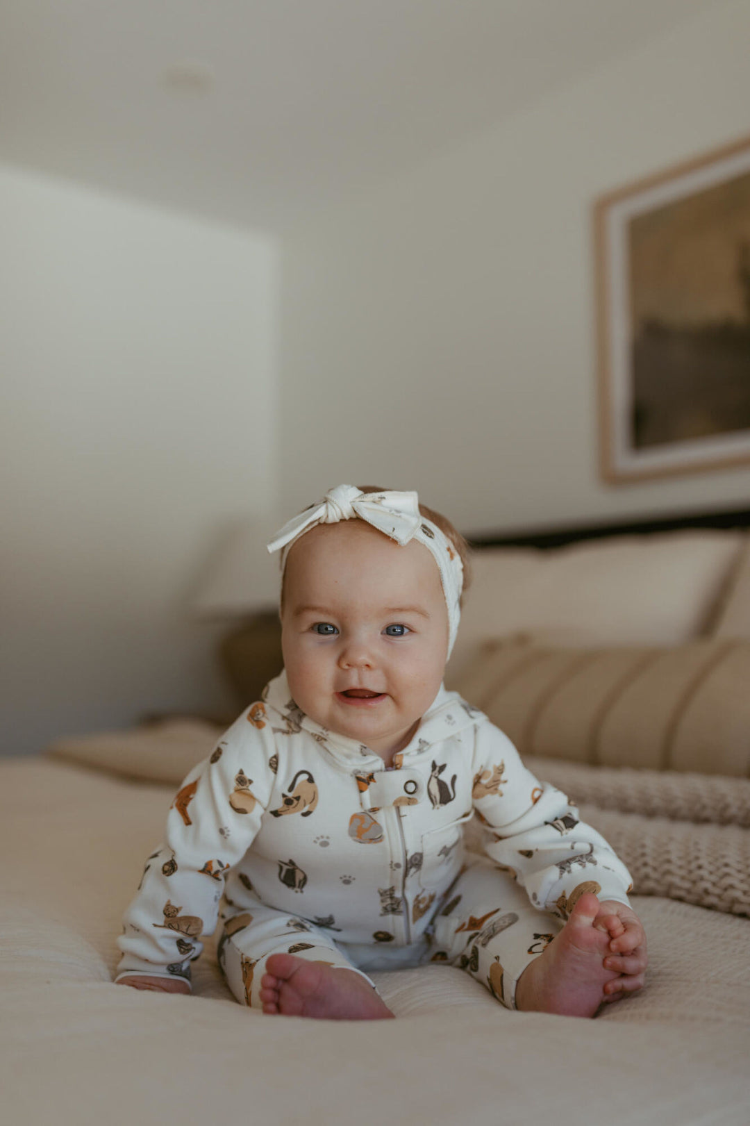 Child wearing Organic Hooded Zipper Romper in 9 Lives.