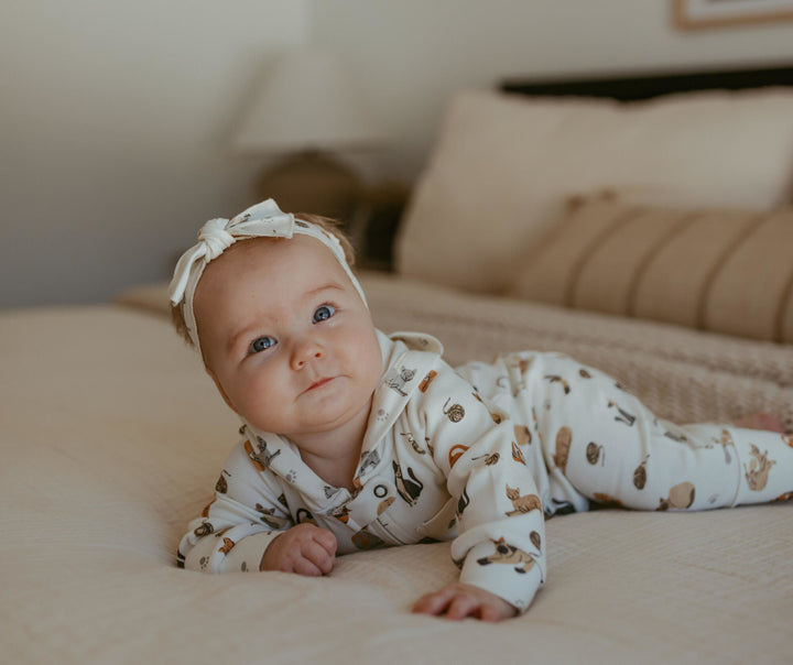 Child wearing Organic Hooded Zipper Romper in 9 Lives.